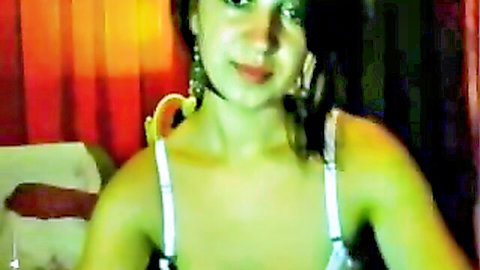 Sexy Pakistani webcam babe smiling seductively in white tank top with hoop earrings