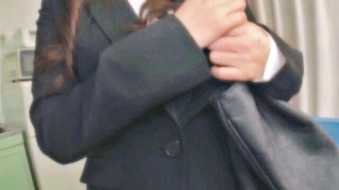 Sexy Japanese office woman in black blazer gripping black leather bag tightly