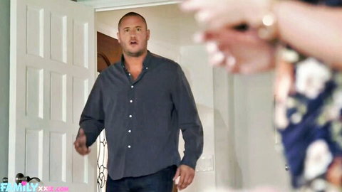 Bald mature man in blue shirt gestures excitedly toward stepmom's hands in floral dress