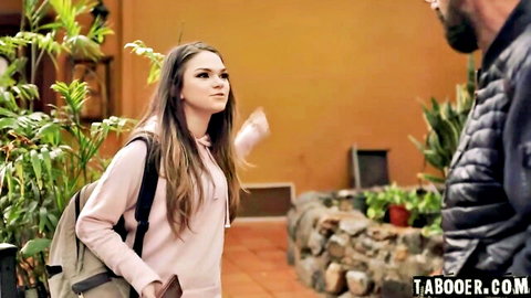 Brunette teen in pink hoodie gestures at bearded older man in taboo outdoor encounter