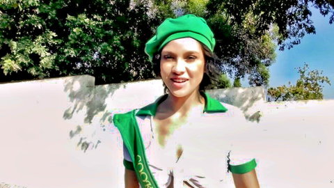 Brunette cock sucking champion smiles provocatively in green beret and cleavage-baring top