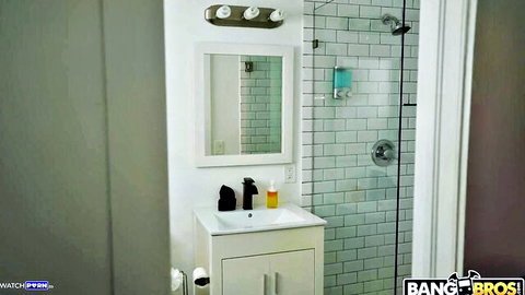 Empty modern bathroom with glass shower, subway tiles, sink and BangBros watermark