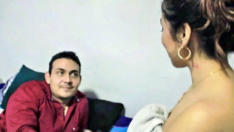 Indian babe with bare back and towel-covered tits teases smiling guy on bed