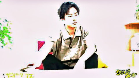 Handsome Asian man sitting casually on yellow cushion in shirt and pants with plants background