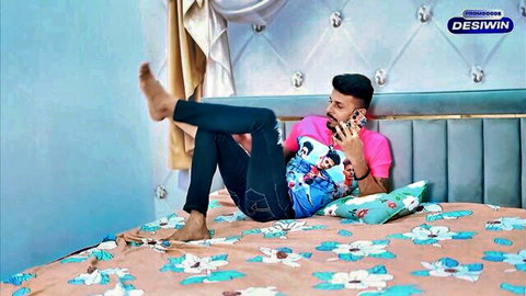 Indian director lounging on bed, teasing MILF in casual bedroom scene