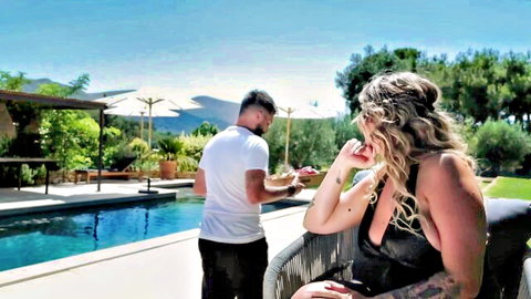 Giulia in low-cut black dress teases guy by pool, blonde bombshell cleavage