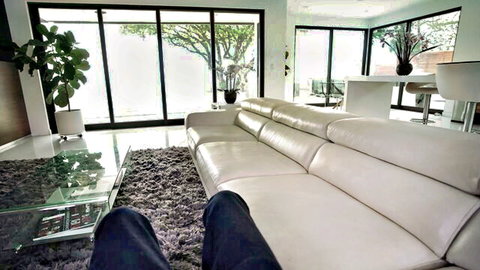 Savannah Bond teasing in jeans on luxurious couch