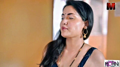 Seductive Indian Bhabhi in black top and mangalsutra, intense expression