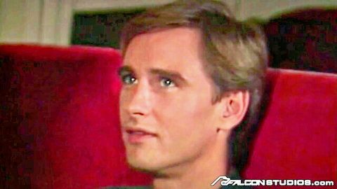Handsome young flight attendant in airplane seat, blue eyes, ready for gay action
