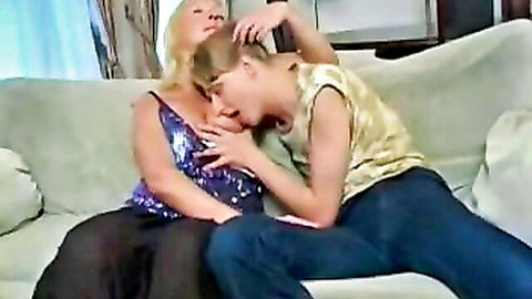 Curvy Russian MILF passionately kissing young man's neck in intimate embrace