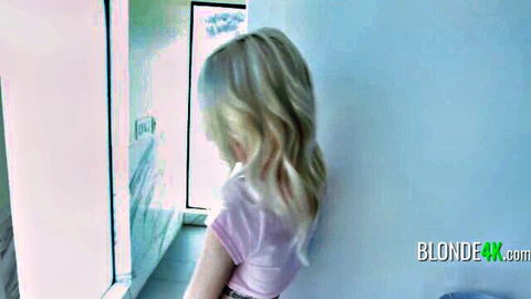 Petite blonde Kate Bloom in pink top and skirt by window