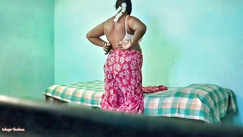 Hyderabad Indian aunty in backless blouse and pink floral saree, curvy back view