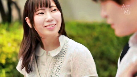 Cute Asian teen in white collared shirt smiling at handsome guy