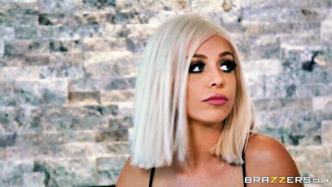 Blonde Madelyn Monroe with bob haircut, seductive side glance in black top