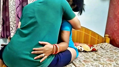 Indian couple in intimate rear hug, woman in blue shorts and top