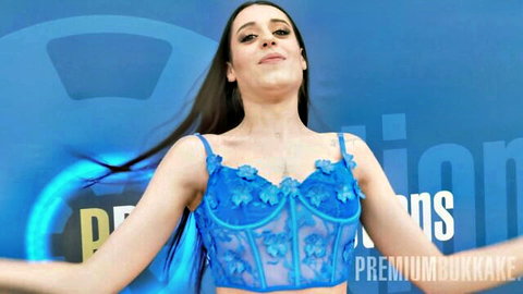 Briseida Myers in sheer blue lace corset, smiling seductively