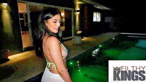 Big titty babe in skimpy white bikini poses seductively by pool