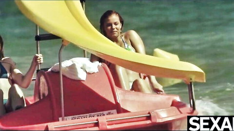 Two hot babes in bikinis enjoy steamy lesbian fun on beach pedal boat
