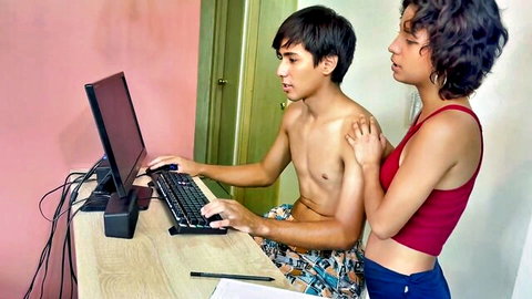 Curly-haired step-sister teases shirtless brother at computer in red top and shorts