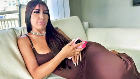 Miss Korinne, sexy Latina in tight brown dress lounging with curves