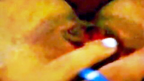 Blurry closeup of Asian babe fingering her swollen pink pussy