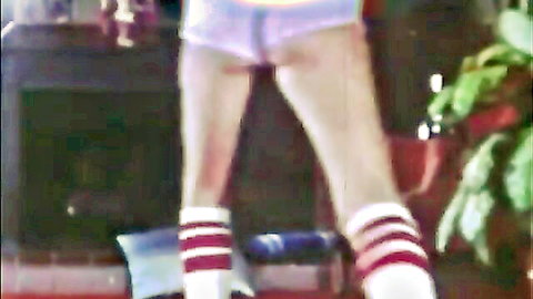 Vintage teen in tiny white shorts and red striped socks stands legs spread showing tight ass cheeks from behind