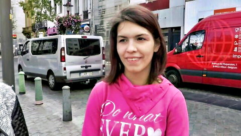 Smiling brunette in pink hoodie outside van, teasing for wild kinky lesbian sex