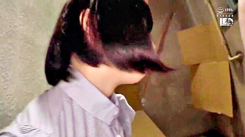 Young Asian woman with bob haircut in light purple shirt, profile view