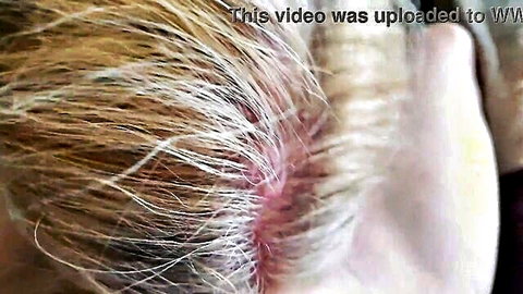 Blonde woman with cum streaked in hair after intense gagging blowjob