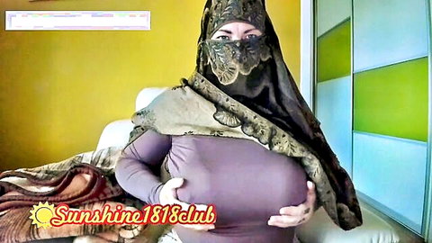 Arab BBW in niqab squeezes her massive tits in tight purple top