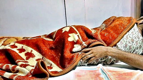 Indian MILF under red blanket with man's hand intimately touching her chest