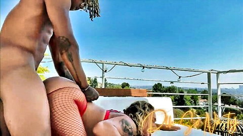 Big black cock neighbor fucks tattooed blonde in fishnet outdoors with city view