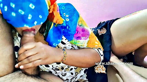 Desi woman in colorful saree gives blowjob to young man