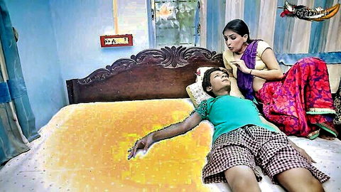 Indian woman in red saree kissing young man's neck passionately on bed