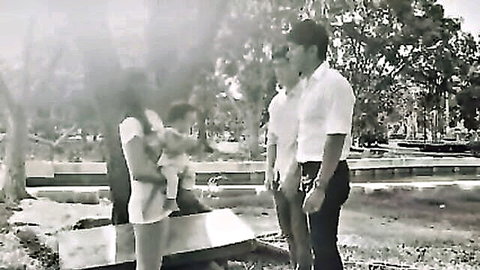 Thai gay romance thumbnail: father and stepson with family outdoors, black and white