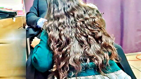 Anny Kitty in green sweater and plaid skirt on teacher's lap for better grades