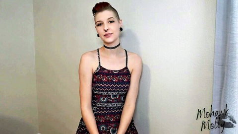Mohawk Molly teases in short patterned dress lifting hem showing thighs