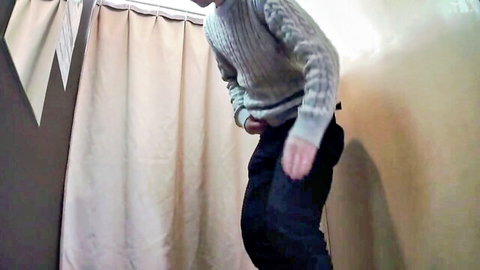 Naughty store employee with hand down pants stroking cock in fitting room