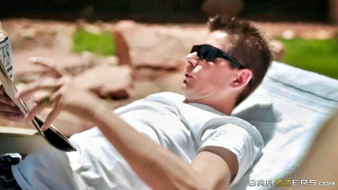 Athletic man in sunglasses and white tee lounging poolside reading magazine outdoors