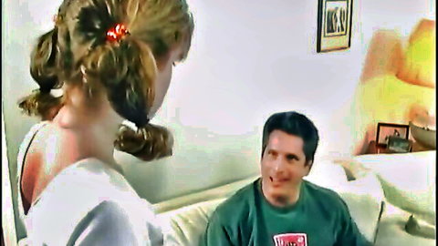 Blonde pigtail teen leaning close to smiling guy on couch in teasing pose