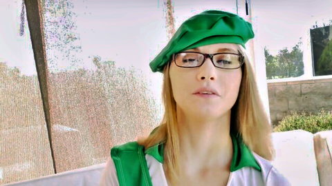 Blonde babe in green beret and glasses poses seductively in sexy outfit outdoors