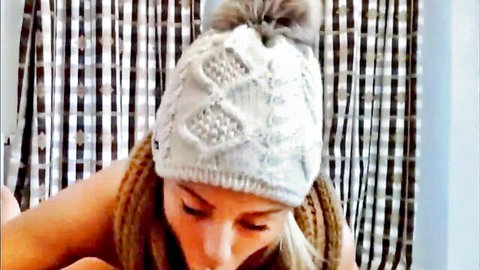 Busty blonde in white pom-pom beanie hat bares her huge tits in closeup POV tease