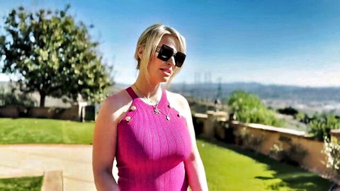 Rachael Cavalli in seductive pink top with cleavage outdoors