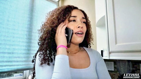 Willow Ryder on phone, curly-haired beauty in blue top, steamy tease