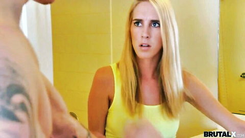 Tattooed muscular guy roughly grabs shocked blonde teen in tight yellow tank top in bathroom