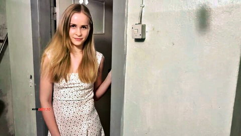 Blonde teen in floral dress teasing seductively in doorway