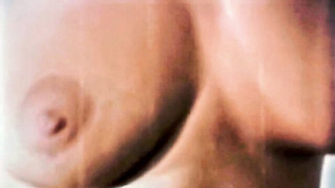 Close-up of woman's erect pink nipple on her big pale tit