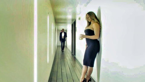 Kayley Gunner in tight black dress, leaning seductively in hallway