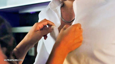 Elizabeth T in intimate shirt adjustment with man in steamy scene