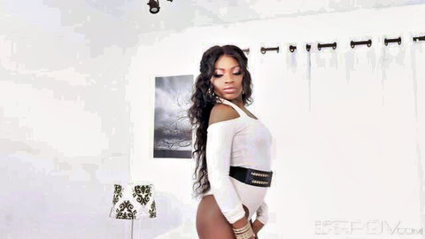 Noemie Bilas in sexy white long-sleeve top and black belt, curvy ebony pose